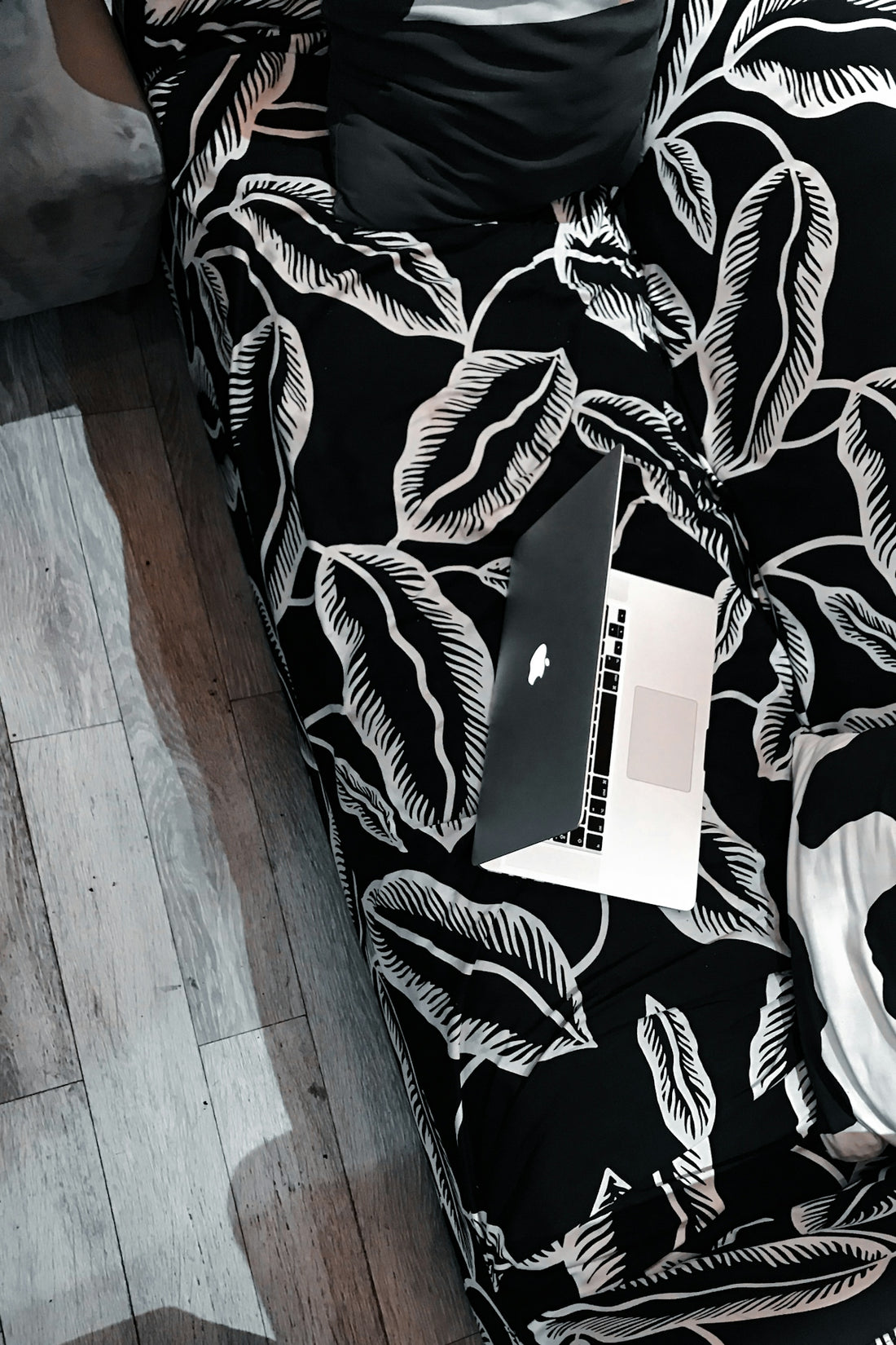 white box on black and white floral sofa