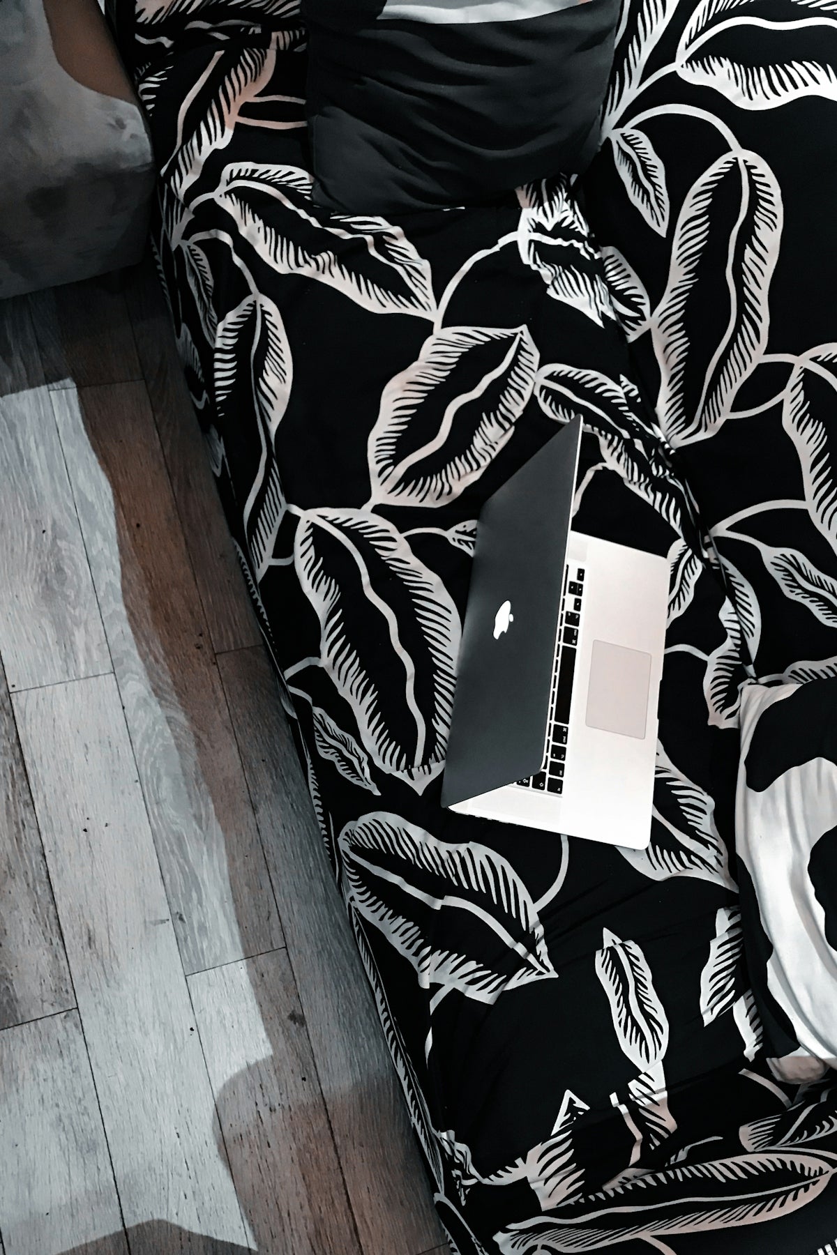 white box on black and white floral sofa