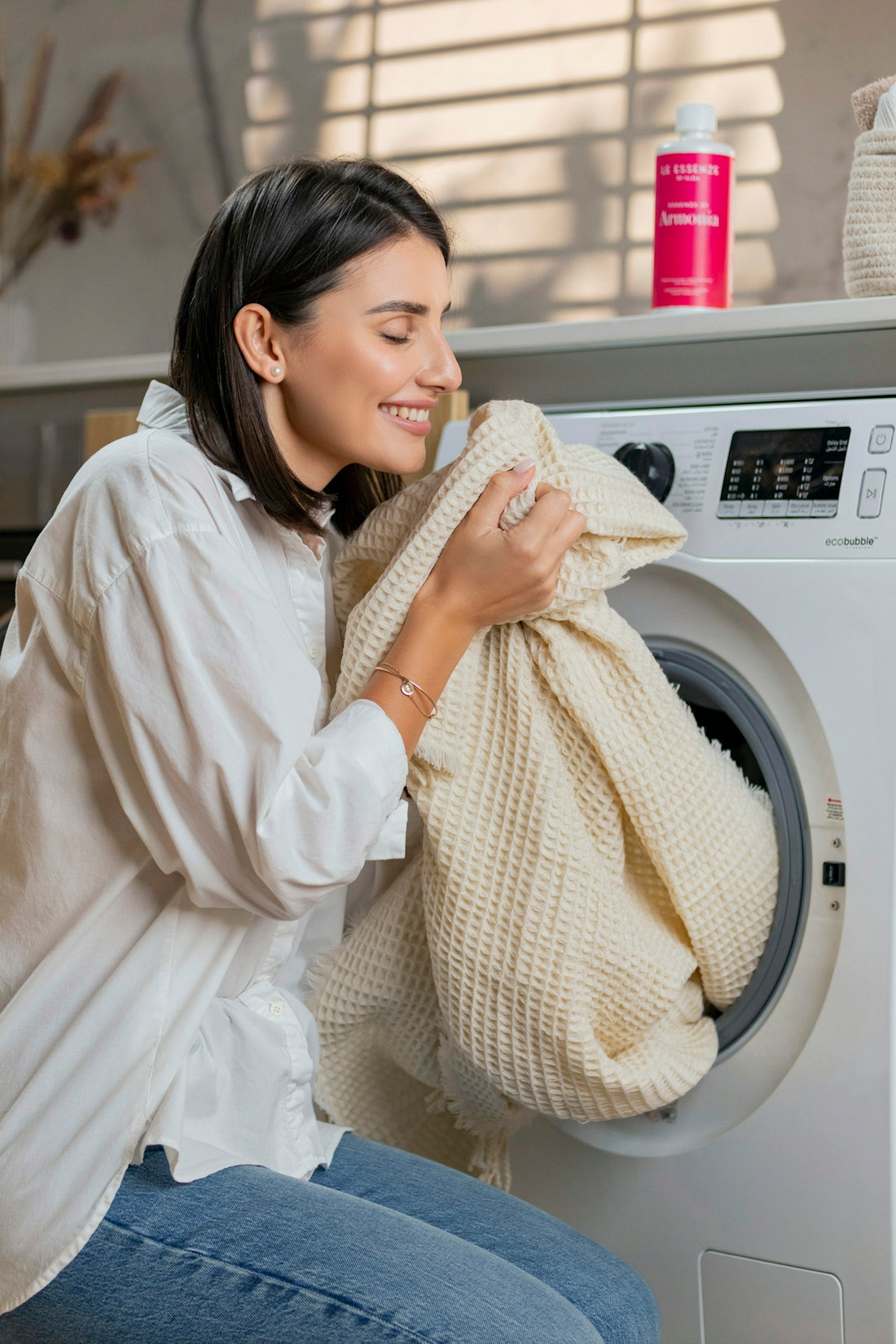 a woman is sitting on a washing machine